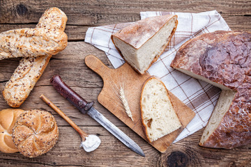 Delicious fresh bread on wooden background