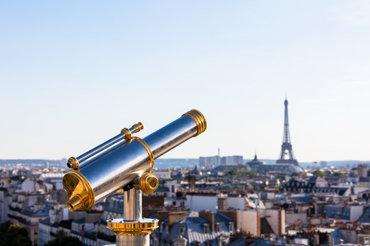 Touristic telescope overlooking Eiffel Tower from the roof of Pr
