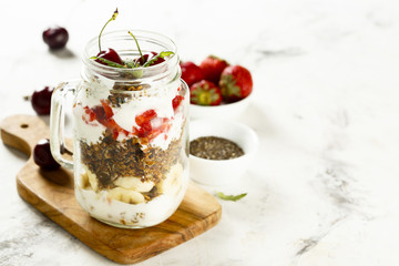 Layered granola with fruits and berries for breakfast