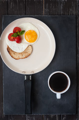 Fried eggs, tomatoes and toast for Breakfast