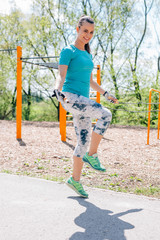 Girl is jumping on the rope in the park.