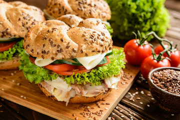 Fish burger with mackerel meat, cheese and fresh vegetable