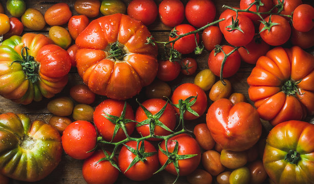 Colorful tomatoes of different sizes and kinds, top view, horizontal composition