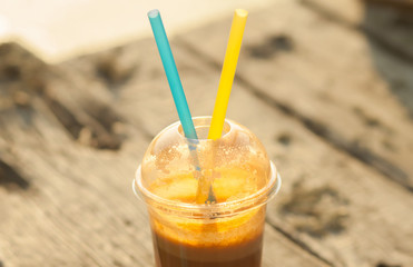 Fresh juice in a plastic cup with two straws