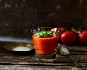Fresh organic tomato juice on a wooden background