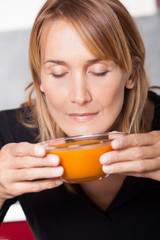 femme sentant de la soupe dans un bol