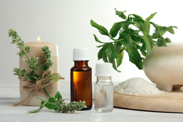Obraz na płótnie Canvas essential oil with bath salt on white wooden background.The concept of aromatherapy