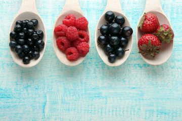 ripe berries in wooden spoon