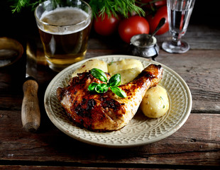 Barbecued chicken leg with boiled potatoes and vegetables