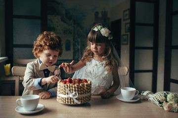 boy and girl having tea party in cafe