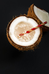 Coconut Water with Pulp on Black Background. Selective focus.