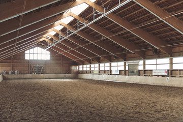 Large vacant indoor equestrian riding school