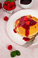 Pancakes with Raspberry Sauce for breakfast. Selective focus.
