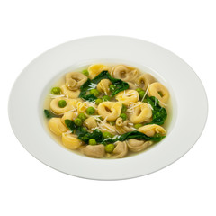 Tortellini Soup with Peas and Spinach Isolated. Selective focus.