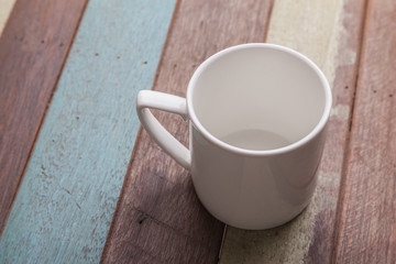 White coffee cup on wooden background