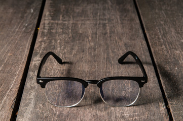 Eyeglasses on wooden table.