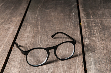Eyeglasses on wooden table.