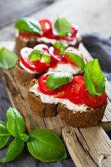 Bruschetta with cream cheese cherry tomatoes and basil