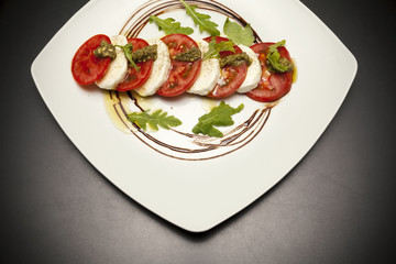starter with mozzarella and tomato.