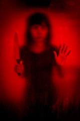 Horror scene of woman with knife behind stained or dirty window glass,Serial killer or violence concept background - 116788437