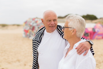 Portrait of senior couple standing by the sea