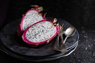 Dragon fruit cut open on a plate