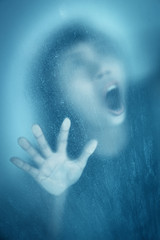 Woman screaming behind stained or dirty window glass,Scary background for book cover