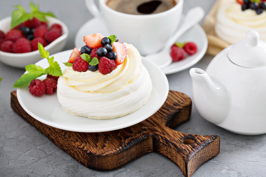 Pavlova cakes with cream and fresh berries