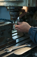 The worker at the metalworking machine