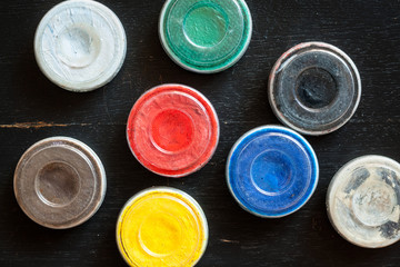 Aquagrim face paints on black wooden background