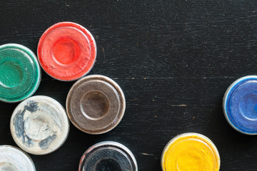 Aquagrim face paints on black wooden background