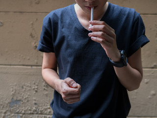 cigarette smoke with lighter and hand