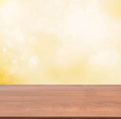 Naklejka na ściany i meble Wooden empty table in abstract gold background