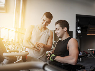 men exercising on gym machine