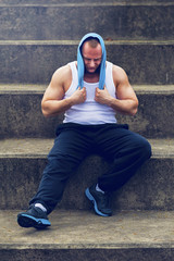 Fototapeta premium Active man resting after workout with towel.