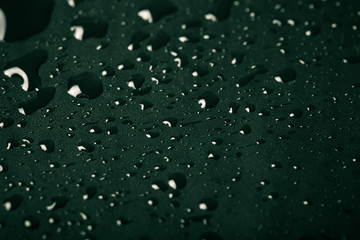 Drops of water on a color background. Green. Shallow depth of fi