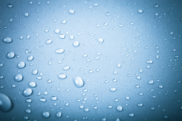 Drops of water on a color background. Blue. Shallow depth of fie