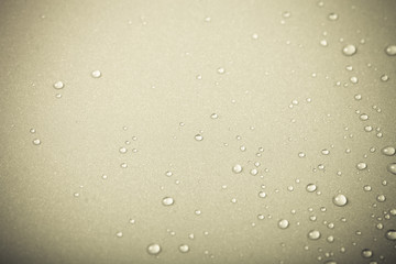 Drops of water on a color background. Beige. Shallow depth of fi