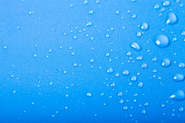 Naklejka na ściany i meble Drops of water on a color background. Blue. Shallow depth of fie