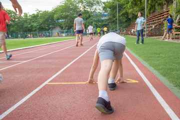 Fototapeta premium The boy ran to in ready position to run marathon