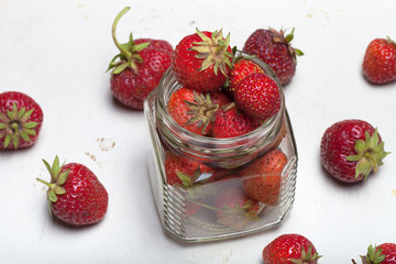 Lots of fresh bright red strawberries on a light background. Sel