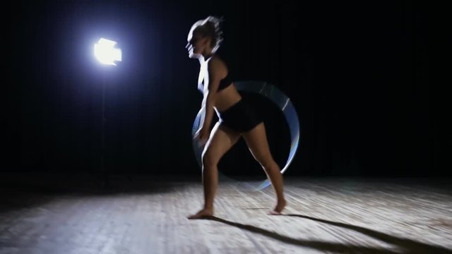 Art gymnastics. Woman with hula hoop.