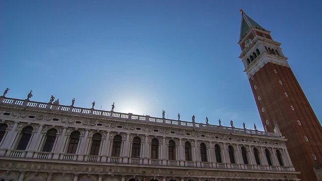 sun falls down behind san marc bell tower venice italy