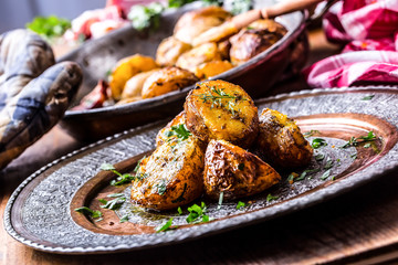 Potato. Roasted potatoes. American potatoes with smoked bacon garlic salt pepper cumin dill parsley - herb decoration.