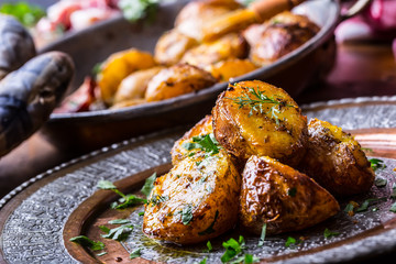 Potato. Roasted potatoes. American potatoes with smoked bacon garlic salt pepper cumin dill parsley - herb decoration.