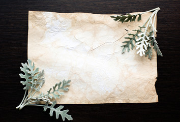 Frame of fresh leaves on ancient yellowed paper. Vintage style. Template for your creativity, invitations, postcards, albums, etc.
