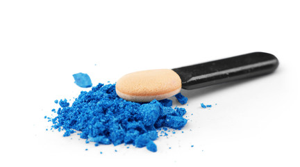Fototapeta na wymiar Professional make-up brush on blue crushed eyeshadow