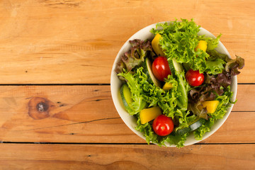 Healthy salad serving in bowl on wood table