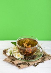 Cup of jasmine tea with flowers with copy space