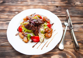 Meat and vegetables salad decorated with teriyaki sauce